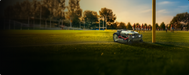 Kress MasterSeries robotic mower beside a sports-field goal