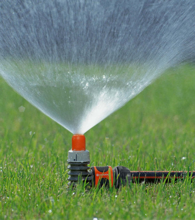 Classic sprinkler in use on lawn
